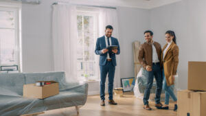 Professional Real Estate Agent Shows Bright New Apartment to a Young Couple